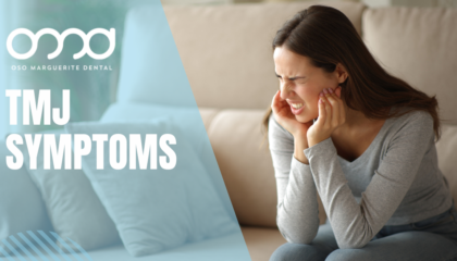 Woman pressing her hands against her jaw and ear from TMJ symptoms