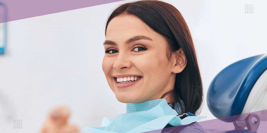 woman wearing a dental bib in a dental chair after a teeth cleaning